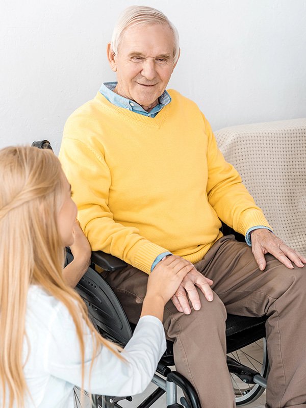 Caregiver with Elderly Man in a wheelchair