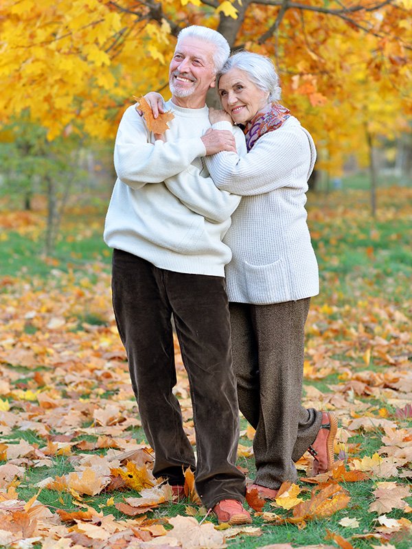 Elderly couple in park with fall colors