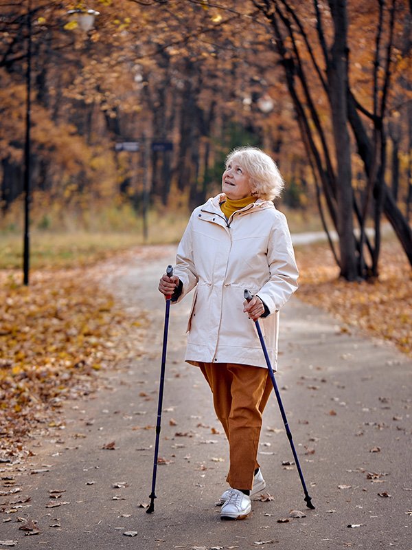 Elderly lady walking on path