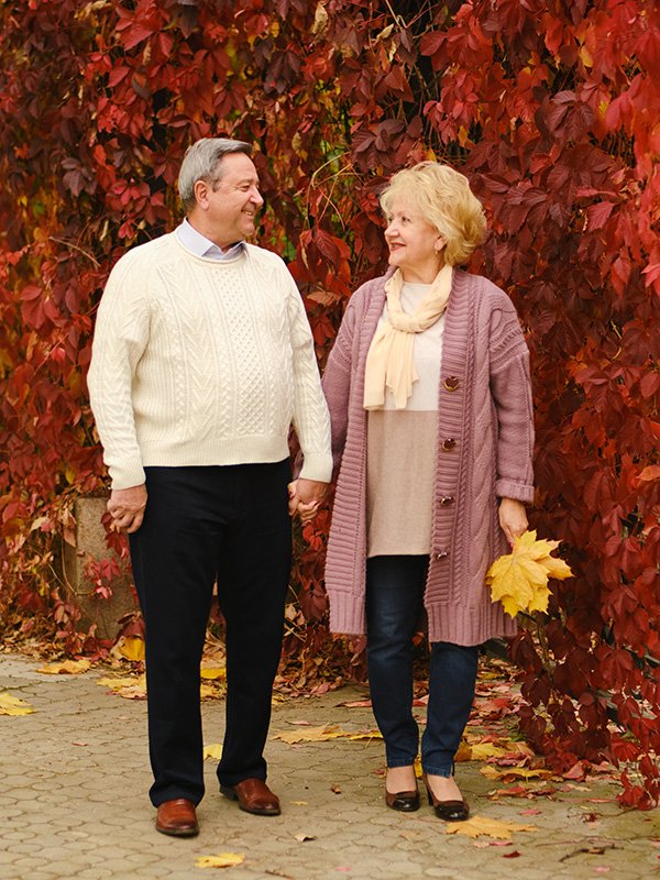 Elderly couple walking down a path