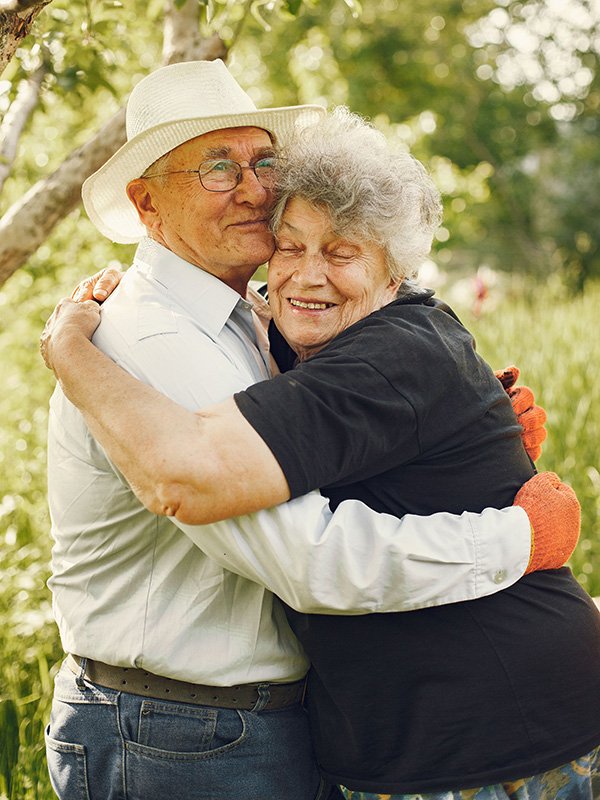 Elderly couple hugging